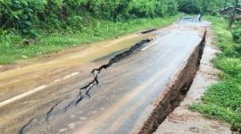 Kondisi Jalan Lintas Parado, Kabupaten Bima, tampak retak dan mengalami penurunan tanah akibat faktor alam dan pergeseran tanah, mengganggu akses transportasi serta aktivitas ekonomi warga setempat.