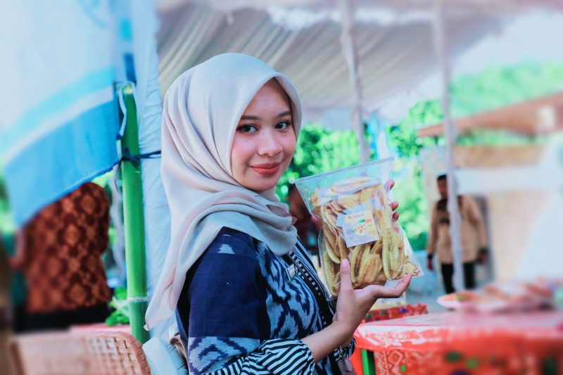 Seorang perempuan memperlihatkan produk makanan inovatif hasil karya masyarakat Desa Bilebante saat Penilaian Desa Berprestasi Tingkat Provinsi NTB Tahun 2026.